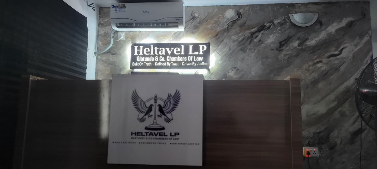 Heltavel Legal reception showing illuminated office signage and the firm's branding