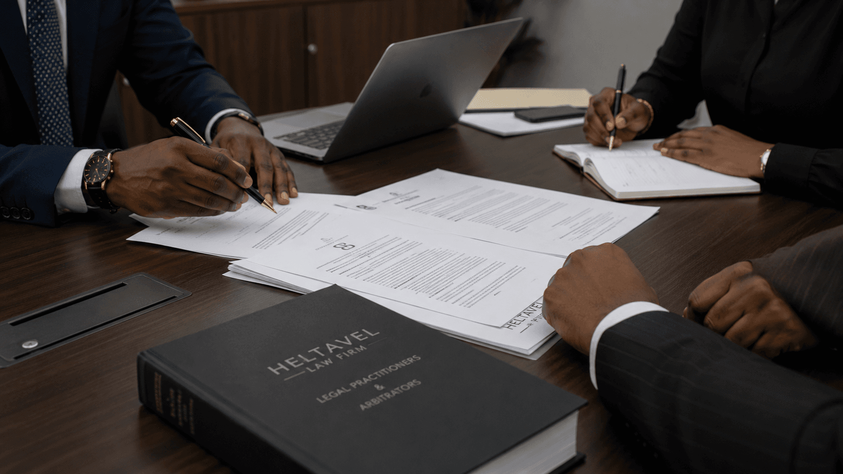 Faceless illustrative image of legal collaboration with documents, laptop, and professional materials